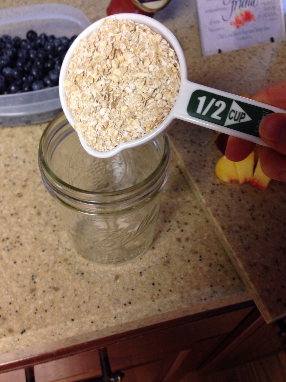 Add 1/2 cup of quick oats to mason jar.