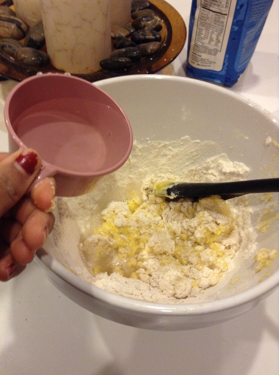 Add 1/2 cup of water to the eggs and flour.