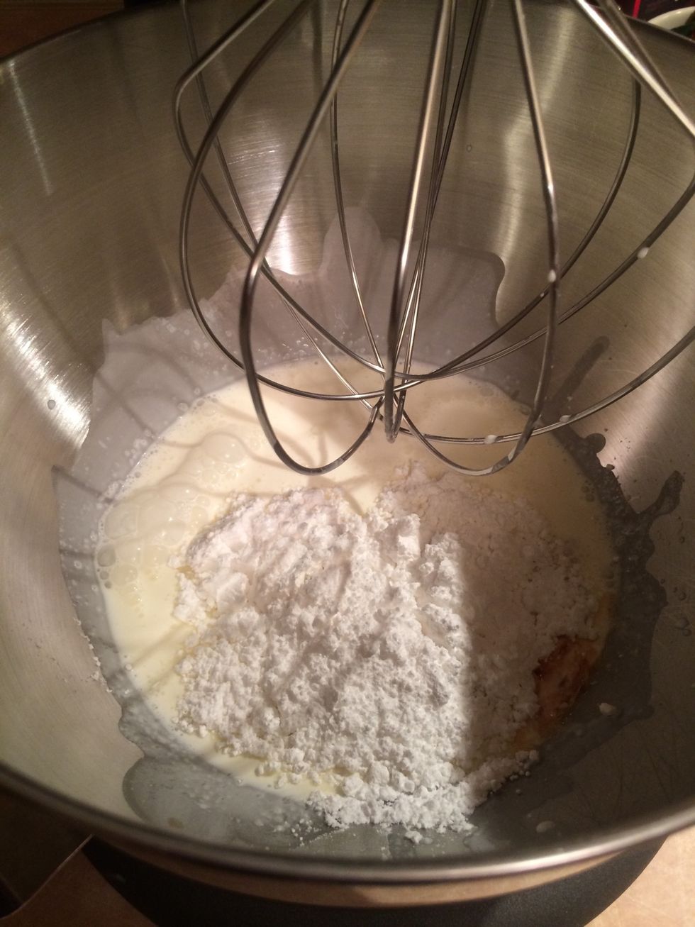 Add 1/2 cup powdered sugar and 1 tsp of vanilla extract. Whip on medium high until whipped stiff. Generously cover the cake with the whipped cream. Cut and serve.