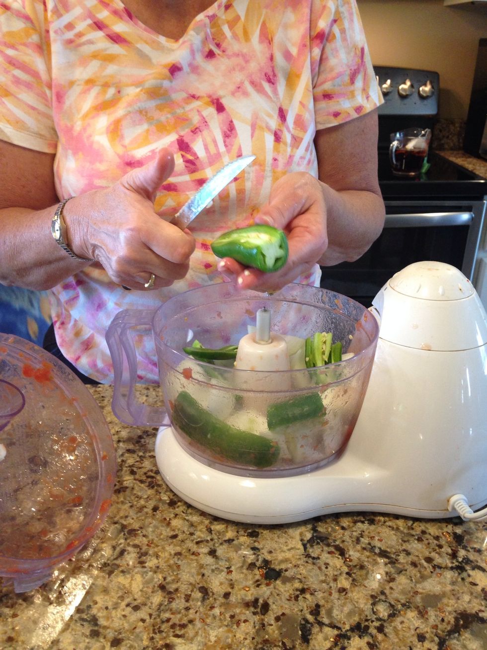 Add 1-2 fresh jalape\u00f1o to food processor. For more heat intensity add the seeds.