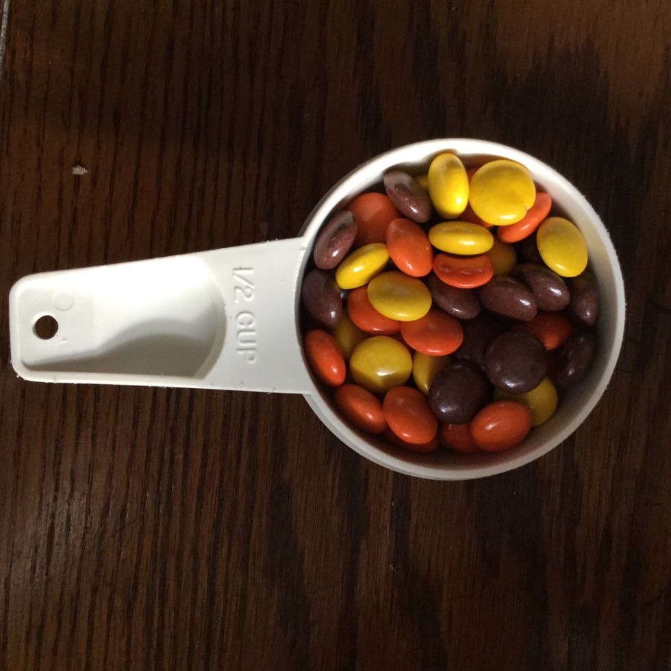 Add 1/2 of Reese's Pieces into large bowl