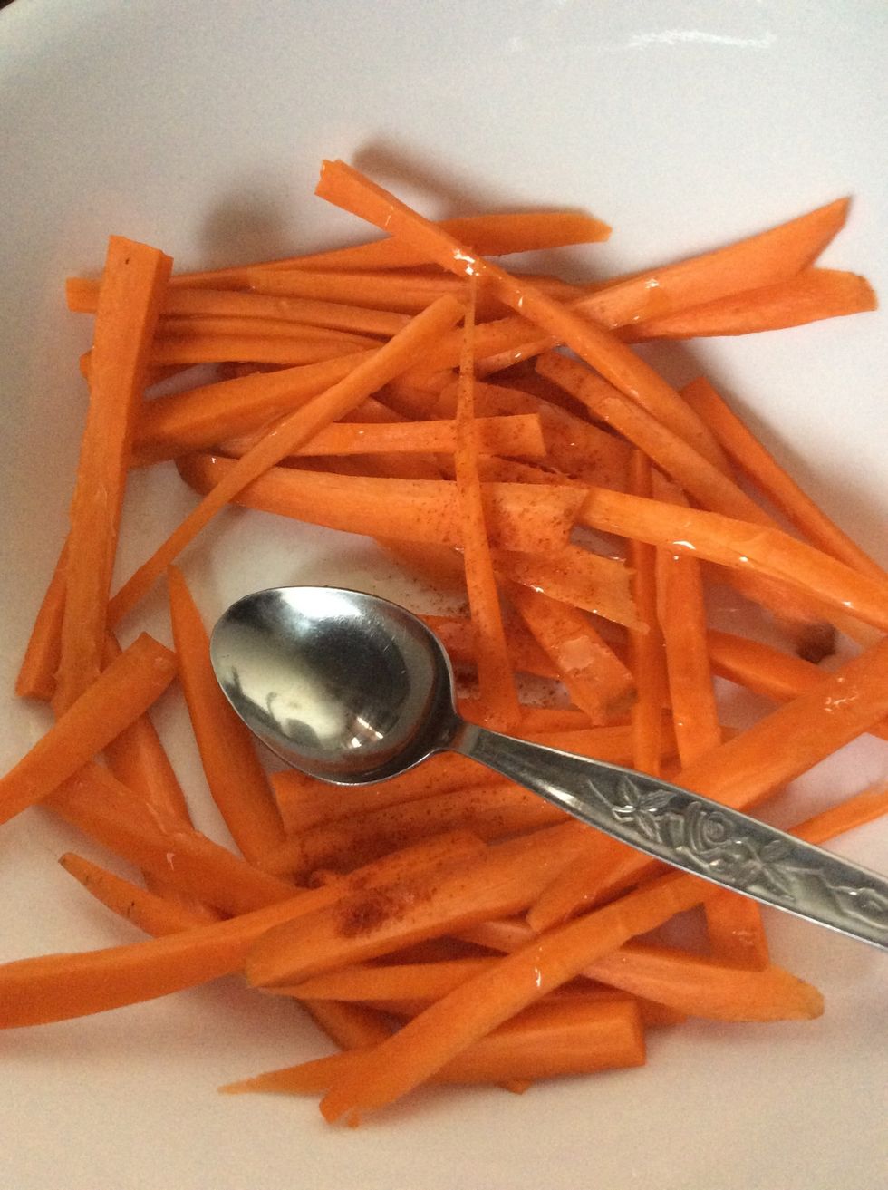 Add 1/2 teaspoon of black pepper and 1/2 teaspoon of salt. Add any additional spices as you wish. Spices should be spread equally among the carrot strips.