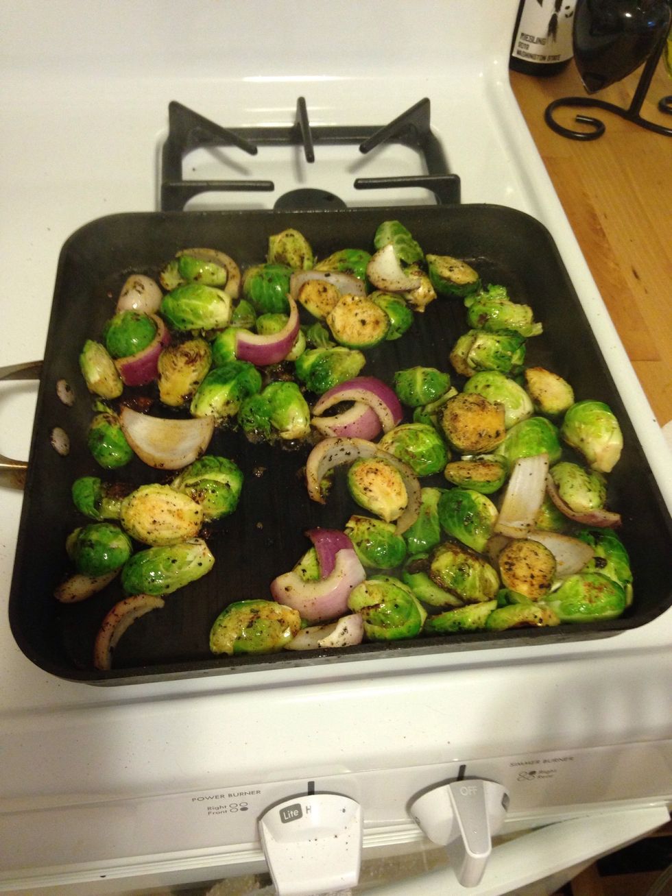 Add 1/2 tsp of black pepper, 1/2 tsp of garlic salt, 1/2 tsp of onion powder, and 1/2 tsp of cayenne pepper to the sprouts.