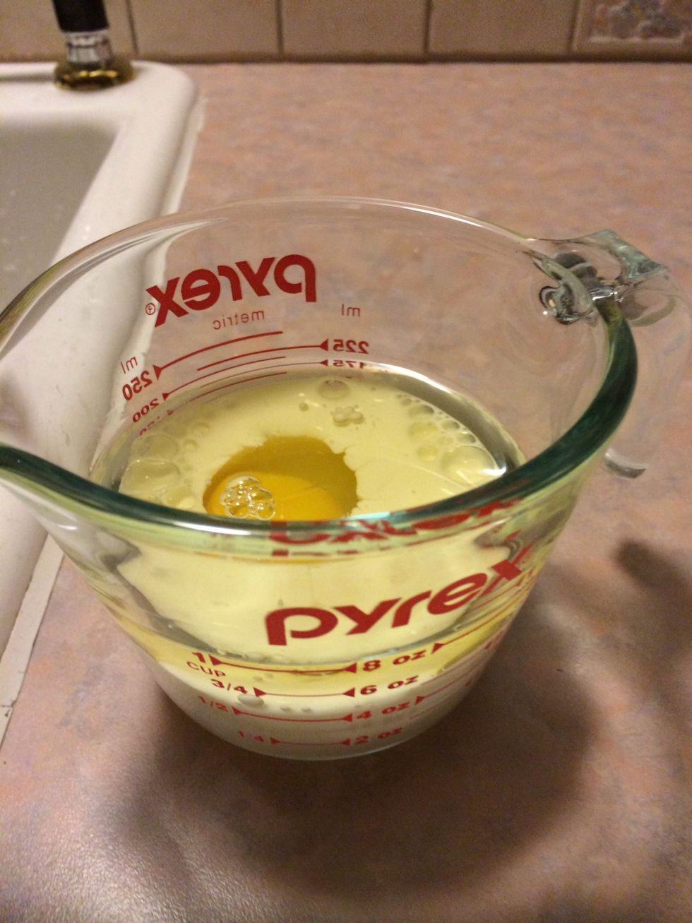 Add 1/3 cup milk, 1/4 cup oil, and 1 egg to measuring cup