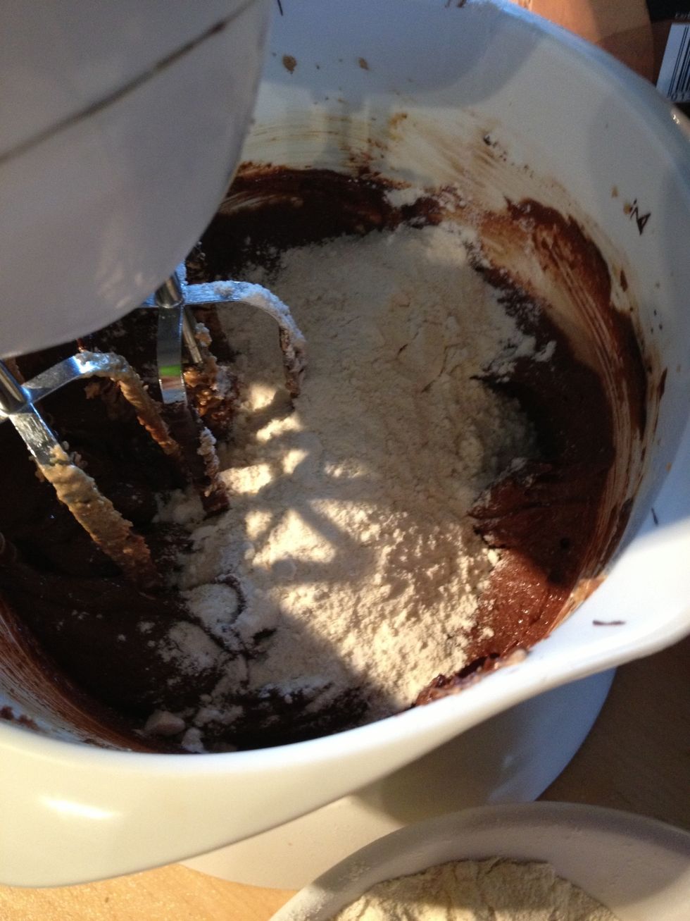 Add 1/3 if the dry flour and raising agent mix, and beat well.