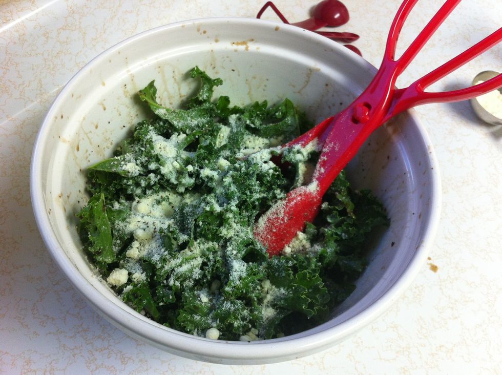Add 1/4 cup parmesan. Continue to toss the kale, adding ground black pepper to taste.
