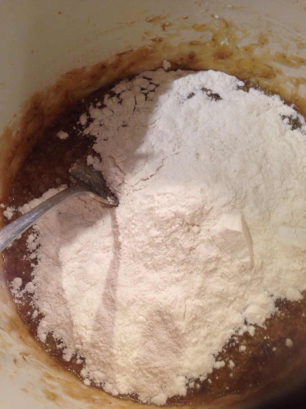 Add 1.5 cups sifted flour and stir with fork