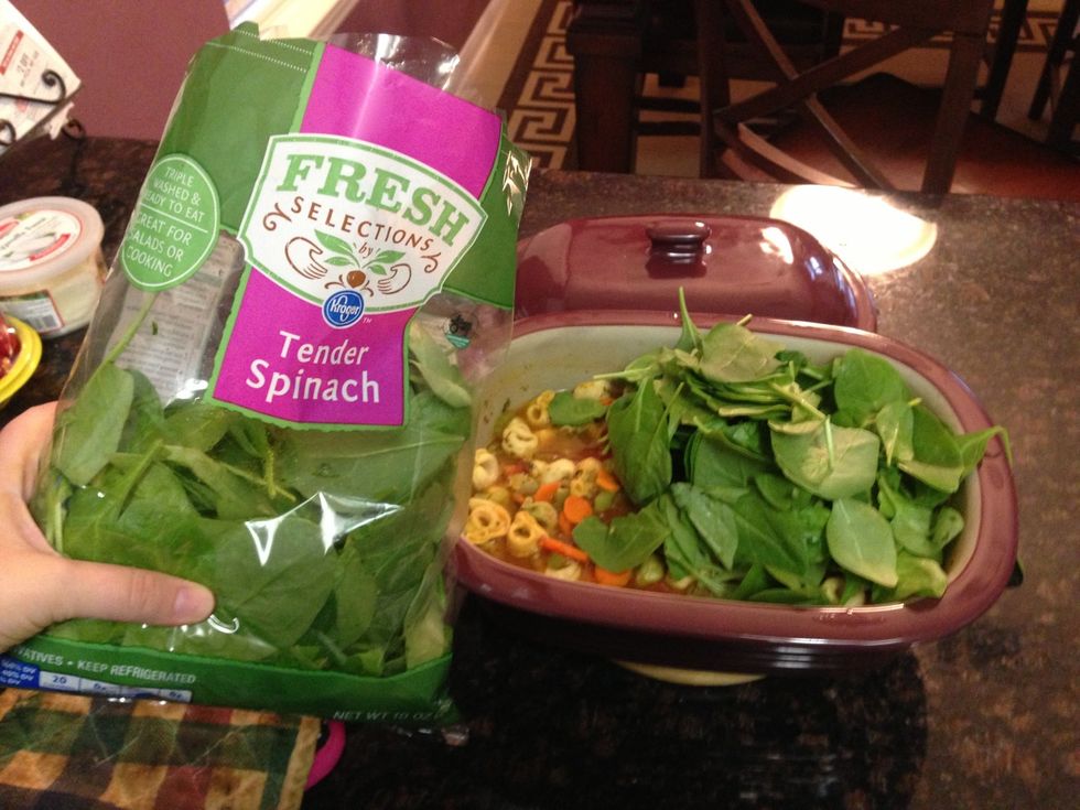 Add 1 bag of baby spinach. You may have to do 1/2 the bag at a time. Then mix and than add the remaining of the bag. Like less spinach, only add half the bag.