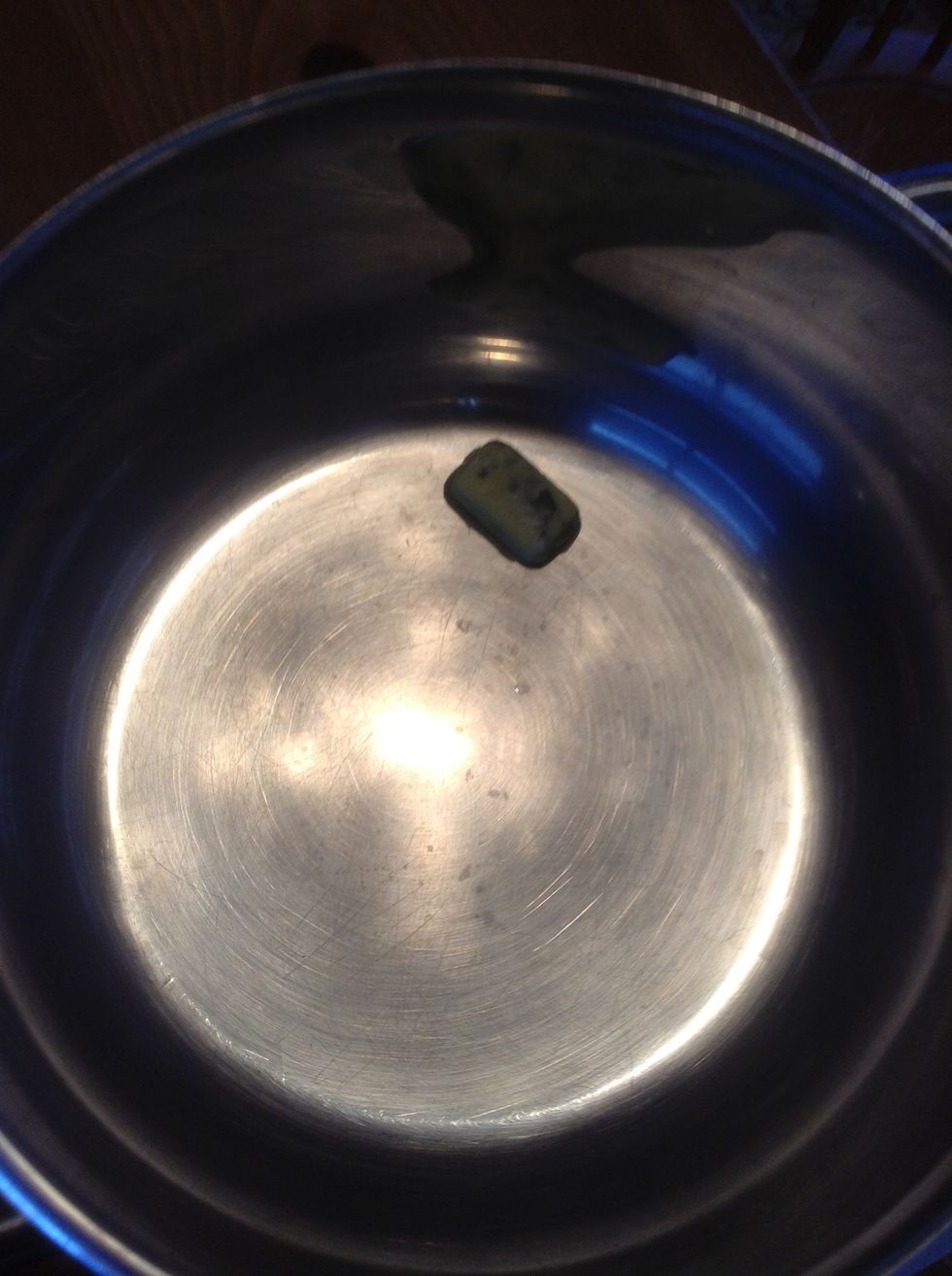 Add 1 basil and olive oil cube to cooking pot.