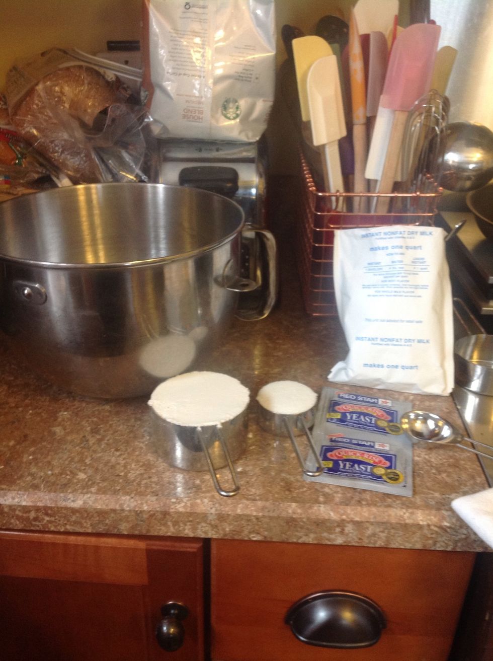 Add 1 c flour, 1/4 c sugar , 2 pkg quick or rapid rise yeast, 2 tblsp instant nonfat dry milk powder and 2 tsp salt to mixing bowl.