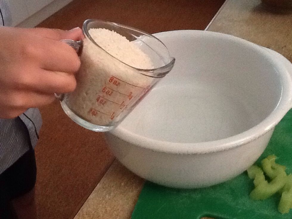 Add 1 cup of rice into a casserole dish.