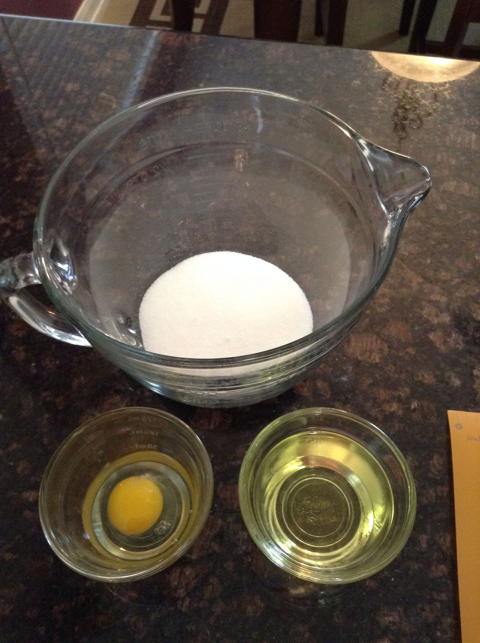 Add 1 egg & 1/2 cup canola oil to the bowl of sugar.