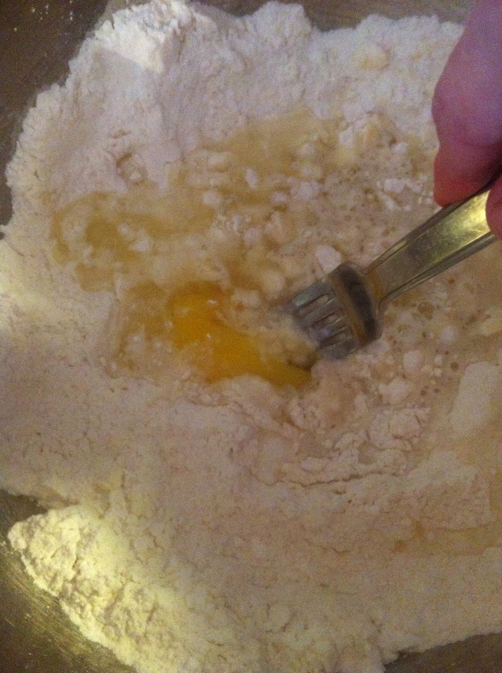 Add 1 egg and 11/4 c whey (leftover from homemade yogurt OR USE EQUIVALENT AMOUNT OF MILK) and stir with a fork until moistened.