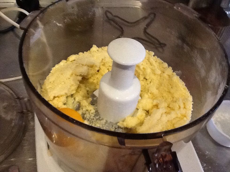 Add 1 egg yolk and 1 1/2 tablespoons of chilled water to the processor.