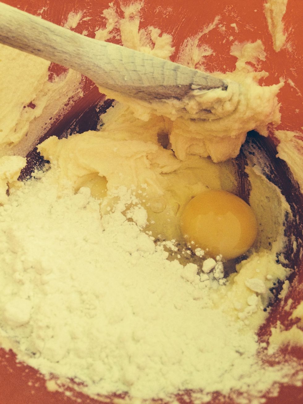 Add 1 of the eggs and half the flour to the sugar and butter mixture