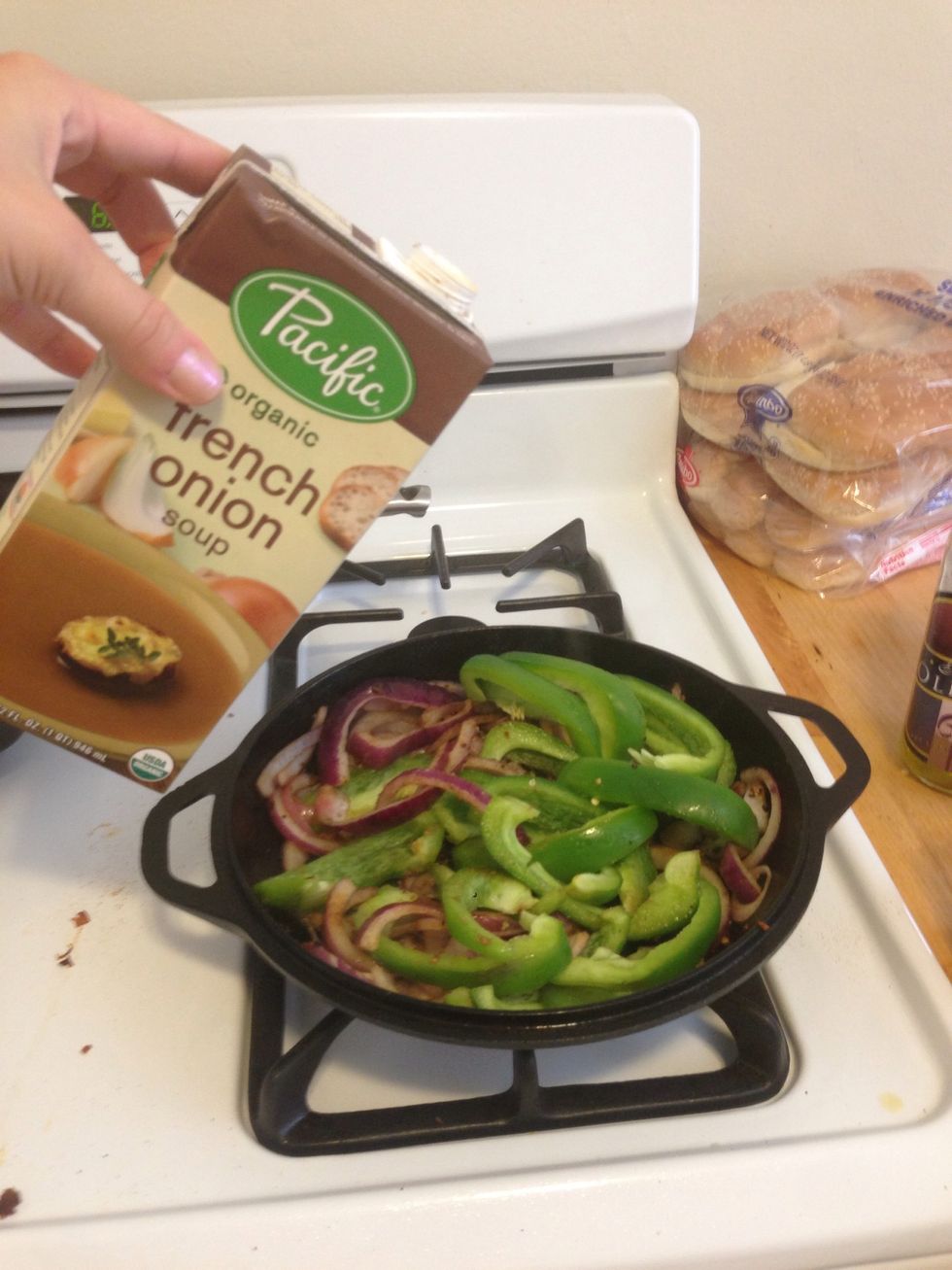 Add 1 oz of French onion soup to the onion mixture. This will make the skillet sizzle, but it will add a lot of flavor to the veggies. Cook the veggies for about 10 mins.