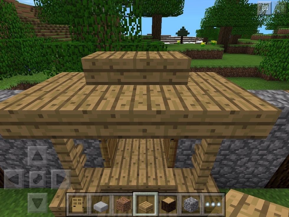 Add 1 slab on top of the pieces of fence and two stairs in the middle