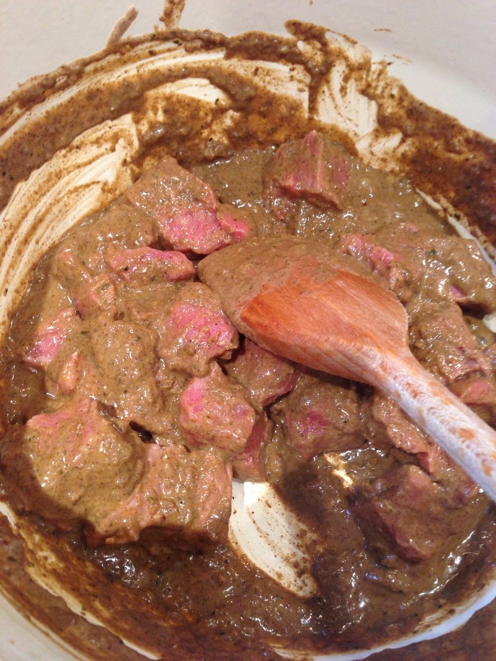 Add 1 tbsp of coconut milk and the curry paste to the casserole dish and heat. Then add the meat and stir until covered and sealed