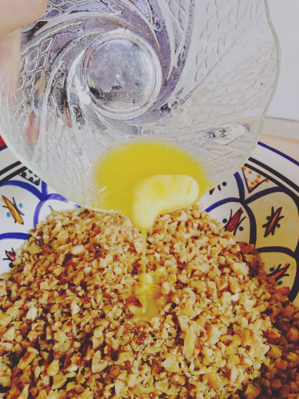 Add 1 tbsp of melted butter to the chopped walnuts and spices and mix well.