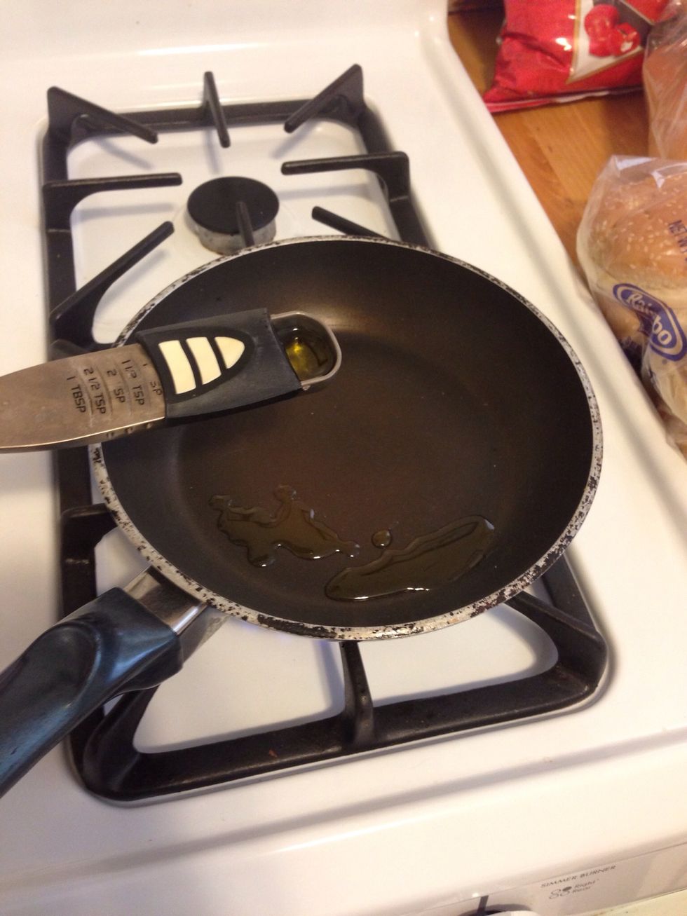 Add 1 tbsp of olive oil to a pan. Turn the burner on high heat.