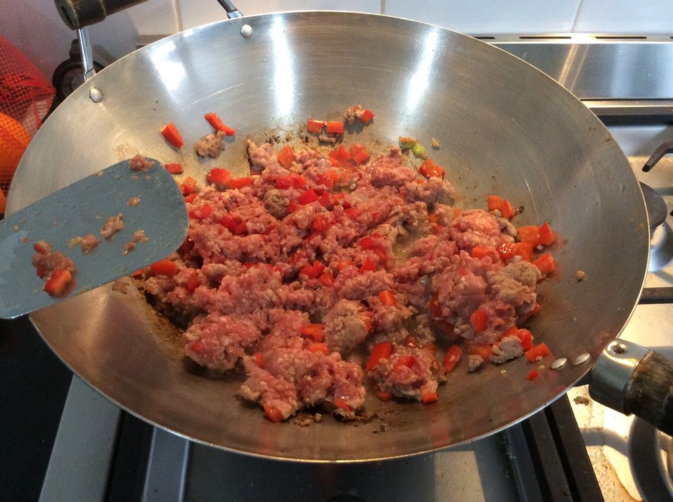 Add 1 teaspoon of peanut oil in a wok. Once it starts simmering, add the bowl of mince with other things in