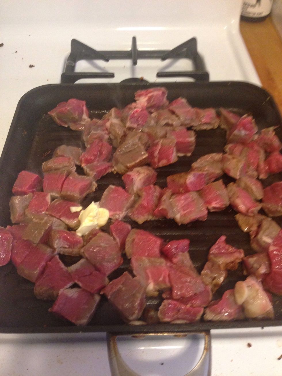Add 1 tsp of sesame oil. When the oil is hot, throw in the steak. Add 1 tsp of butter to the mixture.
