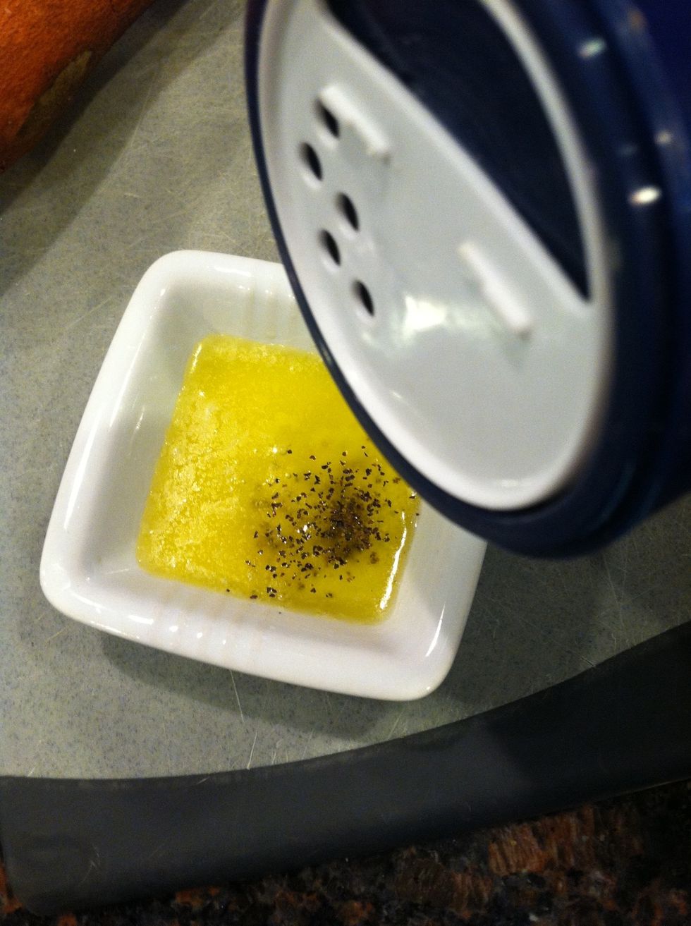 Add 1 tsp olive oil, a few shakes of salt, and about 1/2 tsp black pepper directly to the melted butter. Let the flavors meld while you chop the sweet potato.