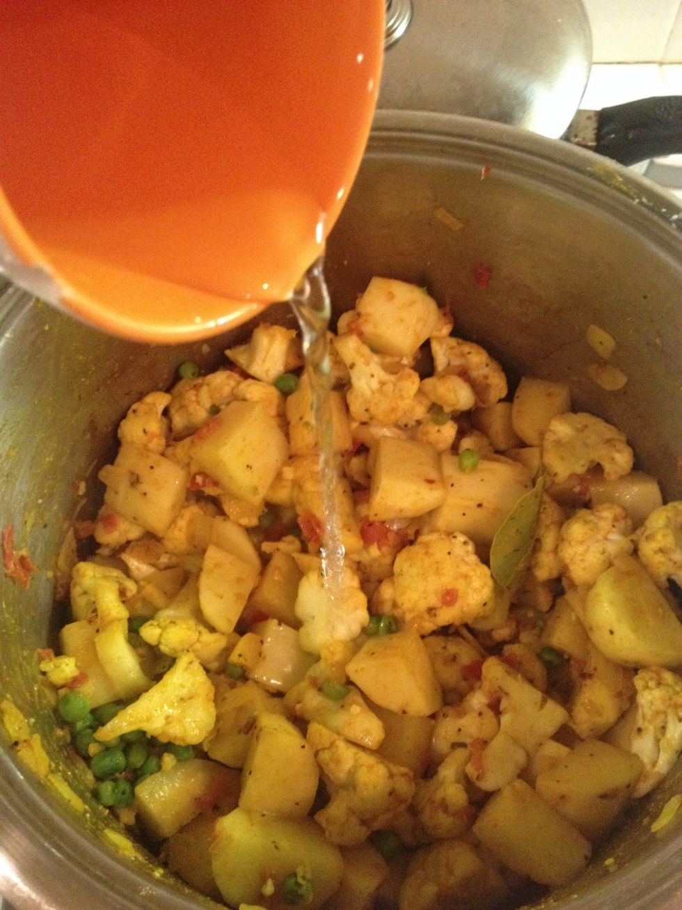 Add 100 mL of water, stir, cover, and leave on medium-high heat for 15 minutes or until potatoes are soft.