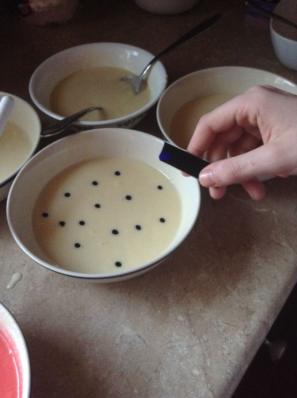 Add 14 drops of blue dye to a separate bowl and mix