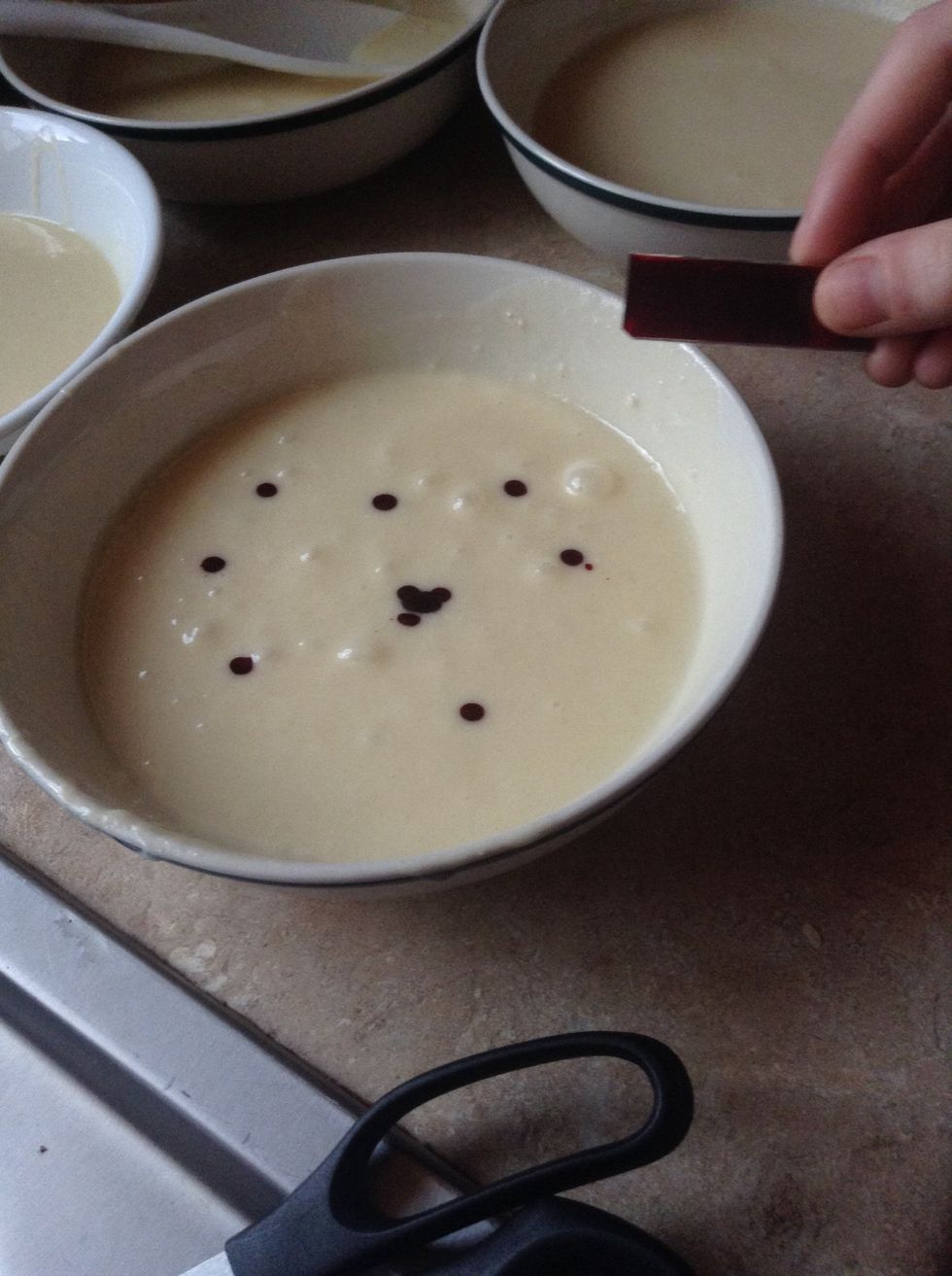 Add 15 drops of the red dye to one bowl then stir