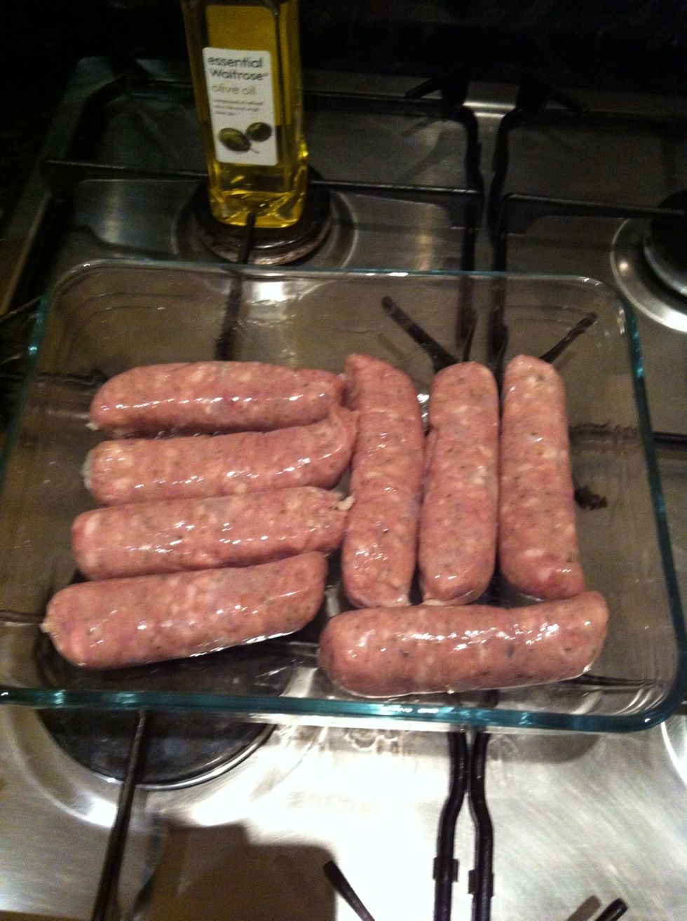 Add 1tbsp of olive oil to your roasting dish (DON'T use Pyrex, I'm using it to show how it cooks and looks!), add sausages and coat well. Put in the oven for 15 mins, turning half way