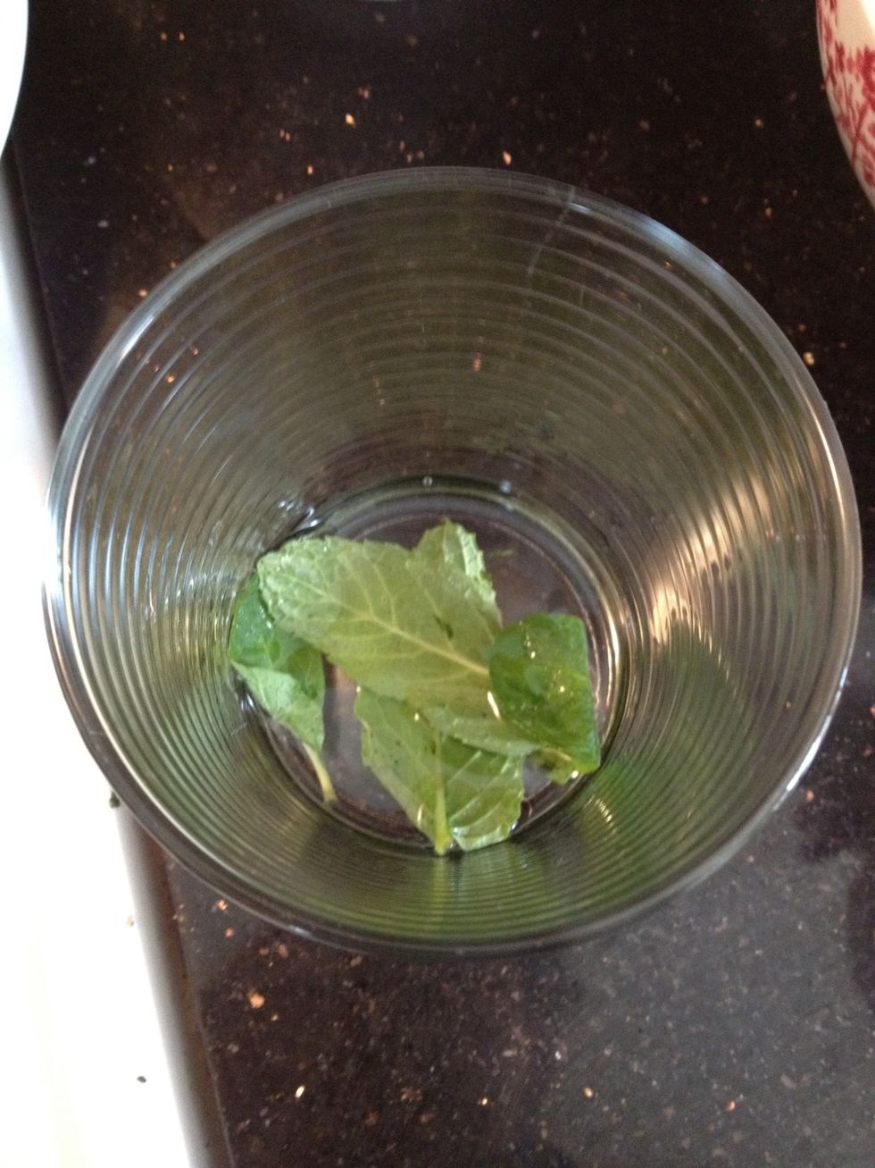 Add 2-3 mint leaves, 1.5 table spoons simple syrup, and a splash of water to your glass. See my profile for my mint-infused simple syrup recipe.
