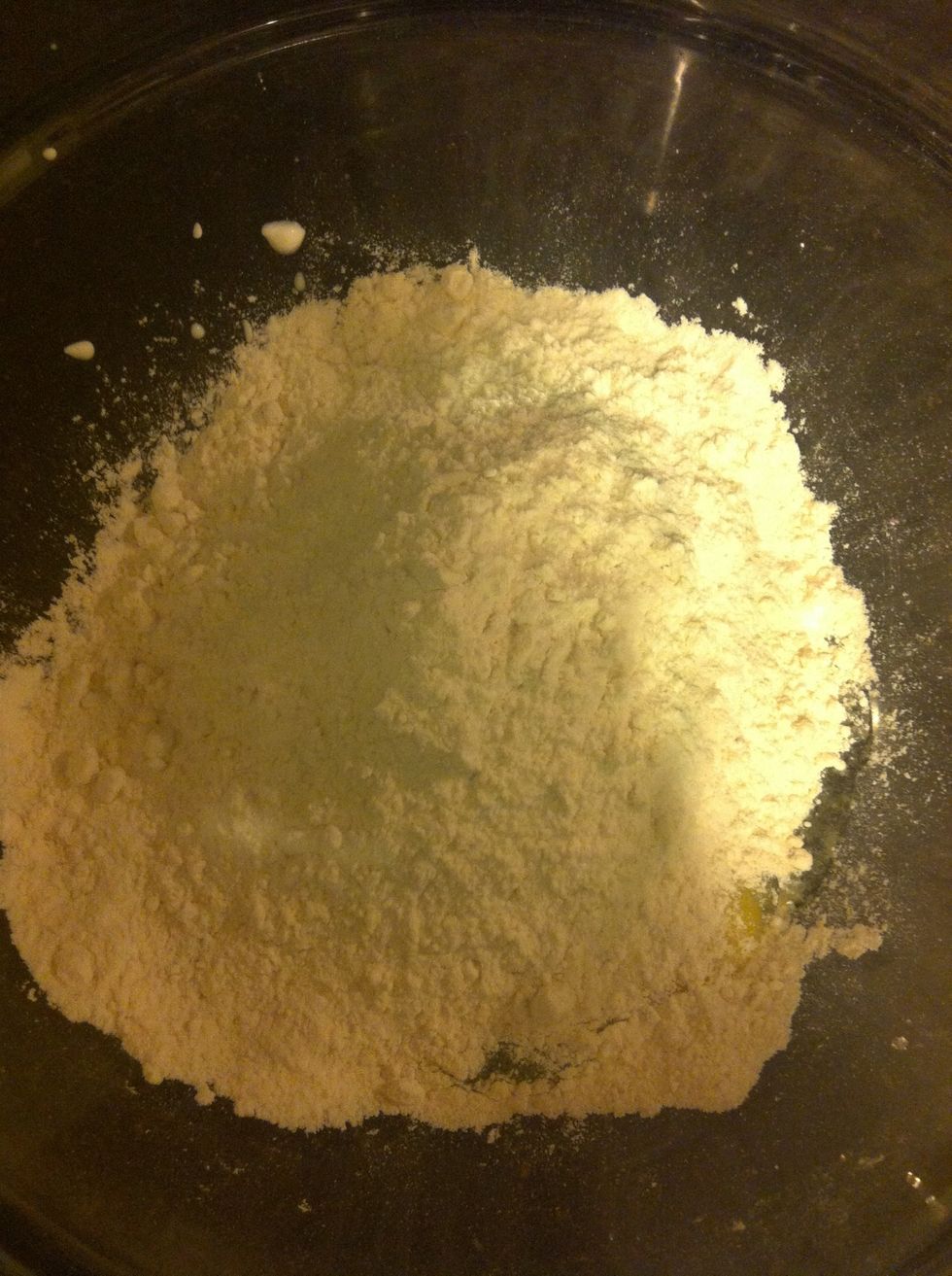 Add 2 cups of flour to your egg and sour cream mixture.