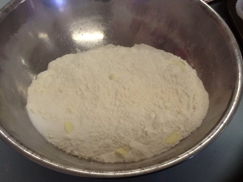 Add 2 cups of sifted flour and mix it with 1/2 a cup of chocolate bits and 1/2 a cup of caster sugar