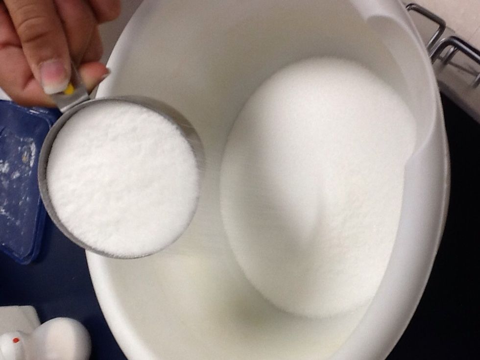 Add 2 cups of your white sugar into the large mixing bowl.
