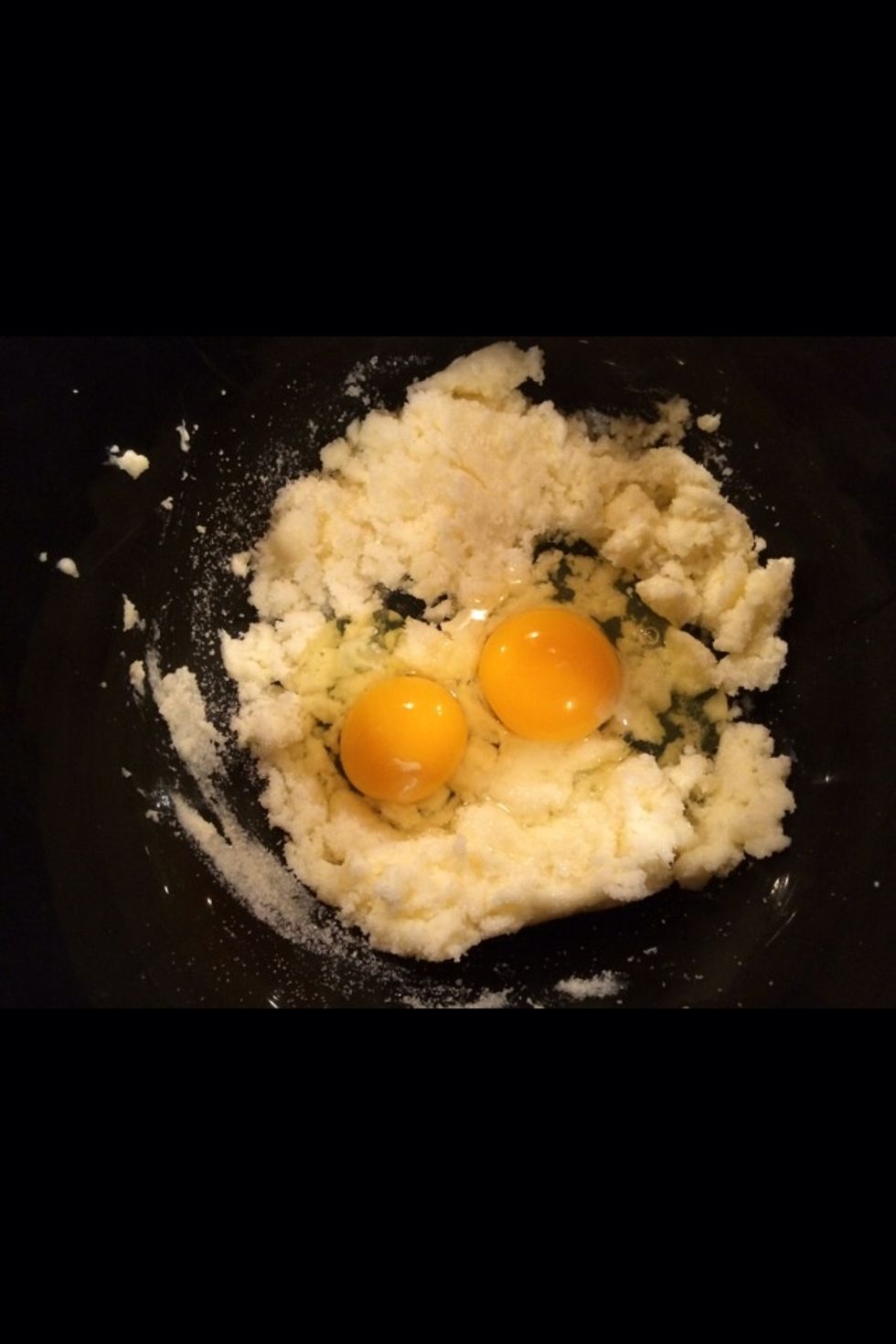 Add 2 eggs to the current mix of sugar and butter