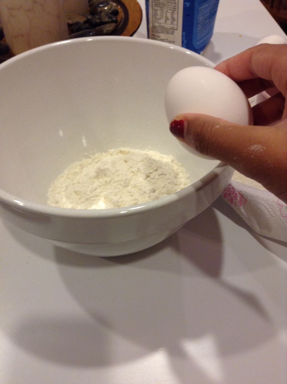 Add 2 eggs to the flour.