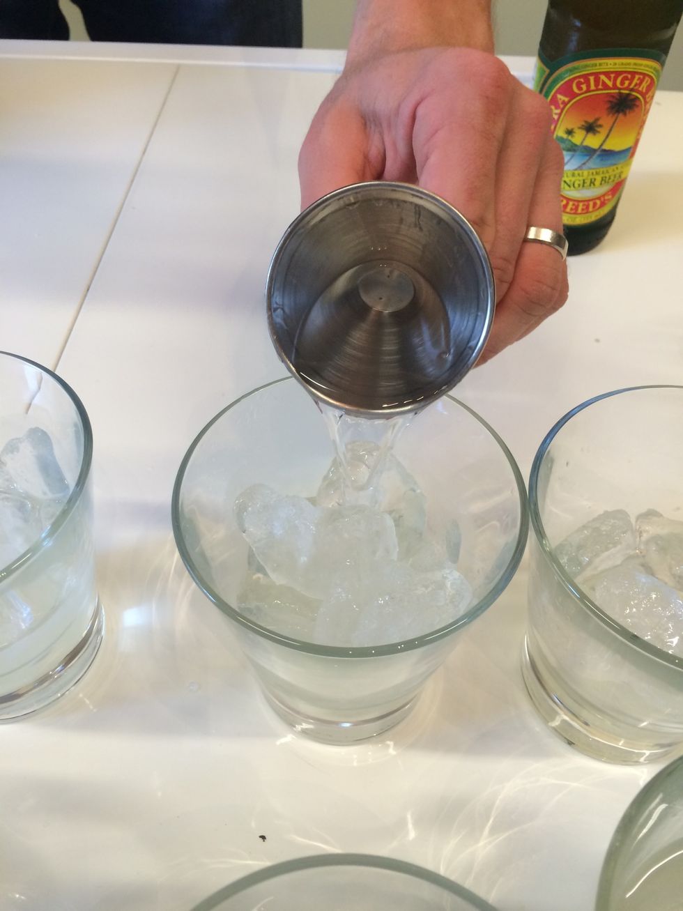 Add 2 ounces of vodka to each cup.