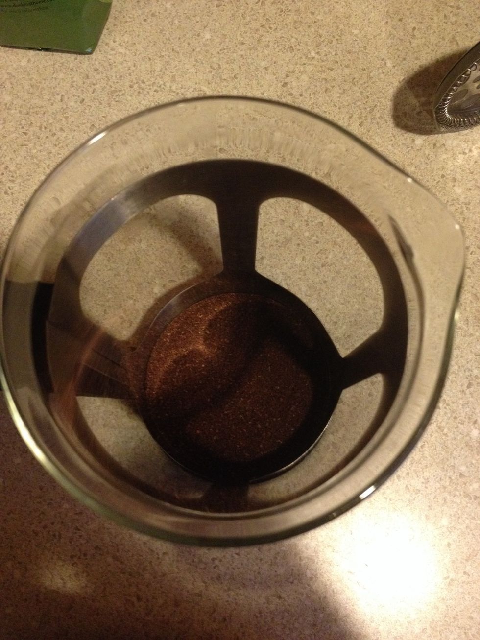 Add 2 scoops of coffee to the French press.