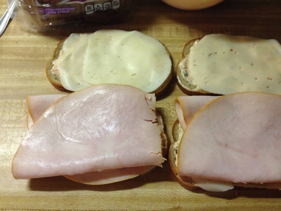 Add 2 slices of turkey to 4 of the slices.