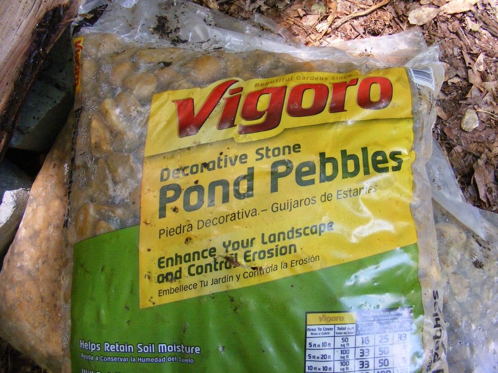 Add 2 to 3 bags of pond pebbles to the inside. This creates an elevated bed for the fire. Better air circulation for the fire.