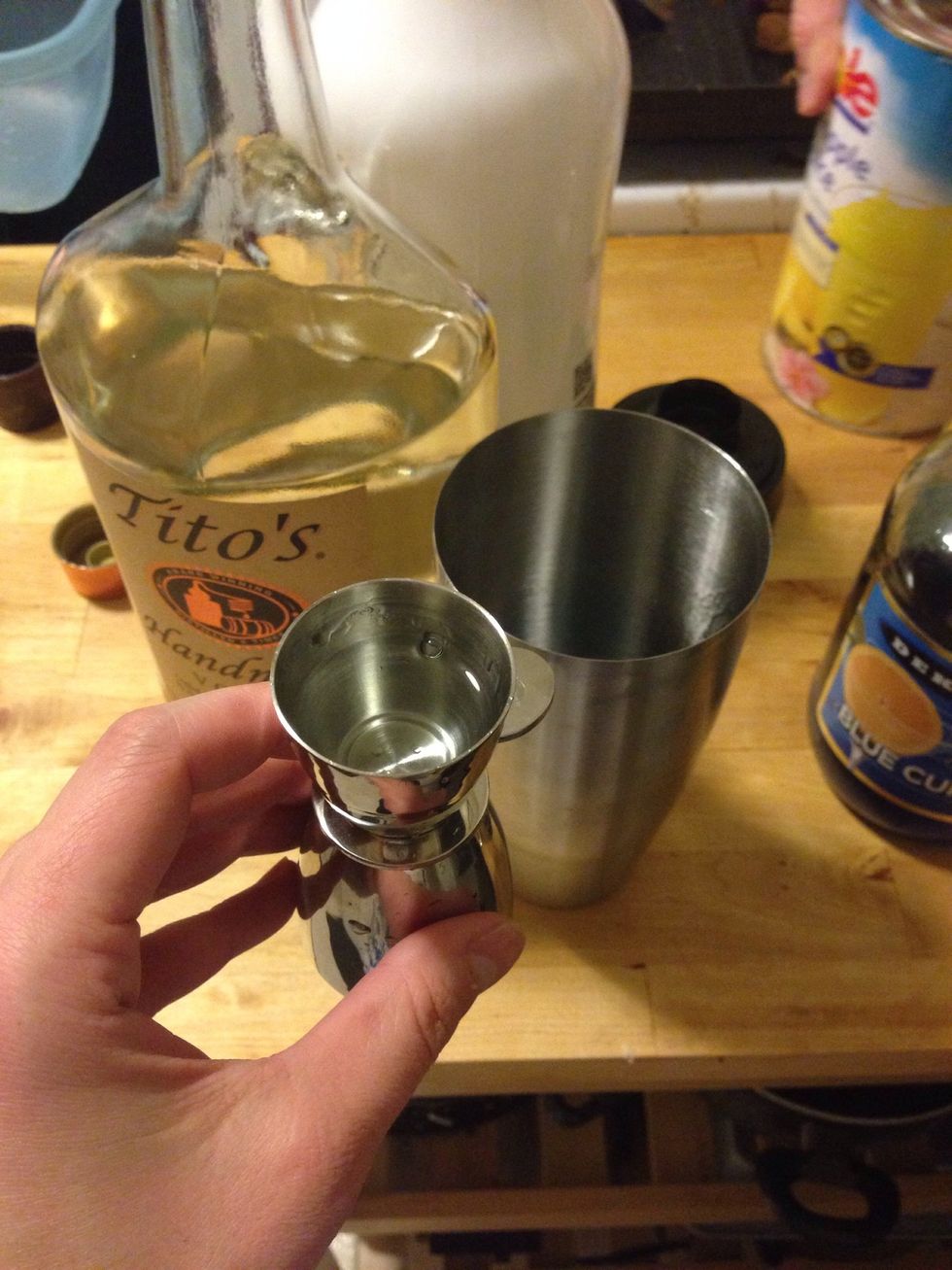 Add 3/4 oz of vodka to the mixing glass.