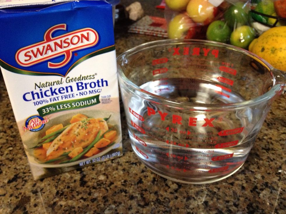 Add 3 cups water and 2 cups chicken broth to the rice in the rice cooker.