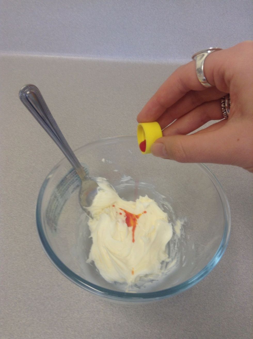 Add 3 drops of yellow food dye to the bowl of icing