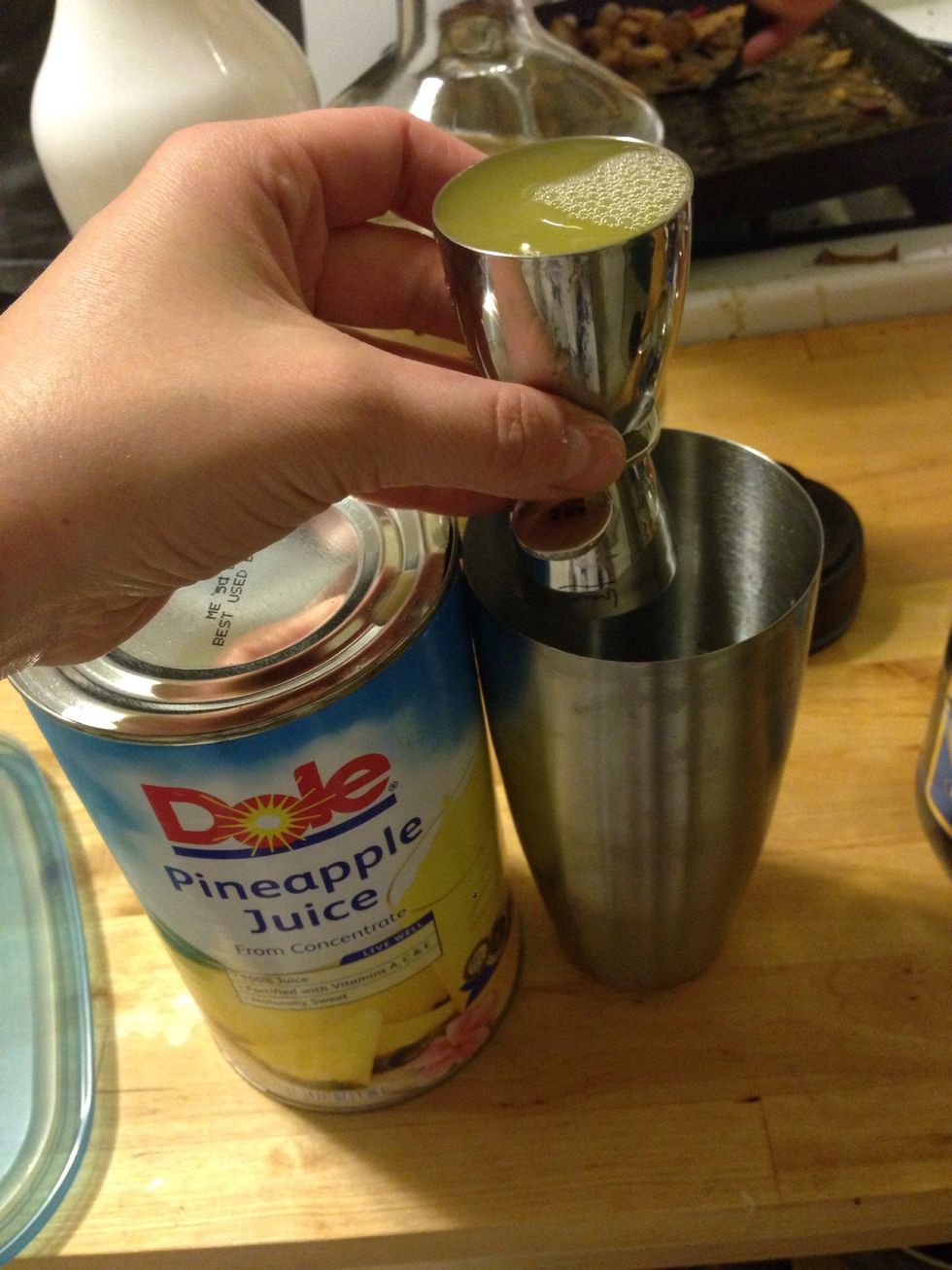 Add 3 oz of pineapple juice to the mixer.