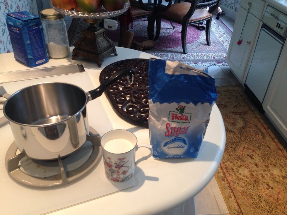 Add 3 small mugs of sugar into the pan and keep the stove at LOW heat. Stir frequently until it becomes caramelized liquid.