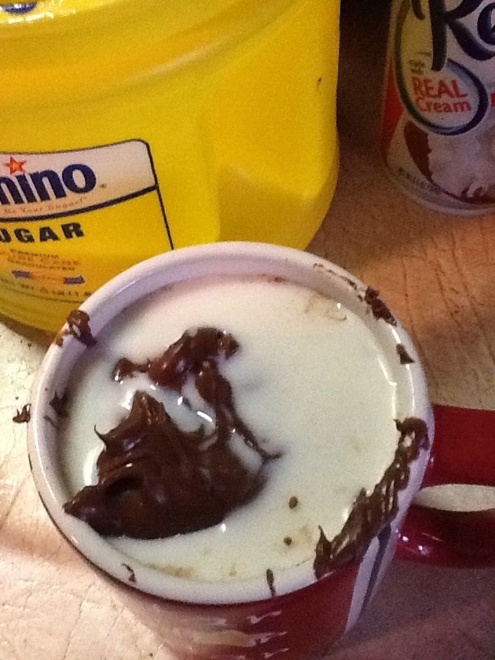 Add 3 tablespoons of milk to your mug.