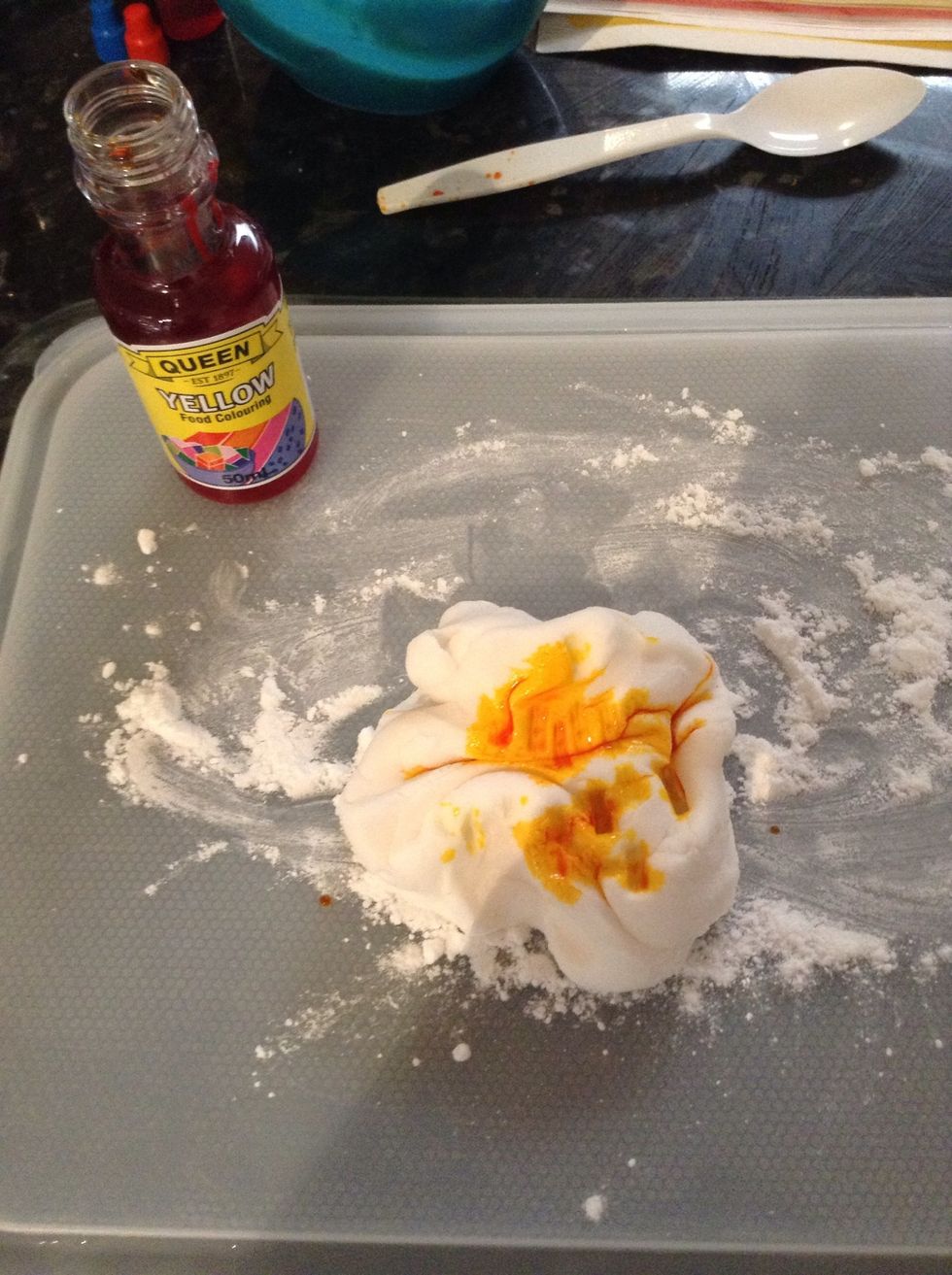 Add 4-5 drops of yellow food dye to icing