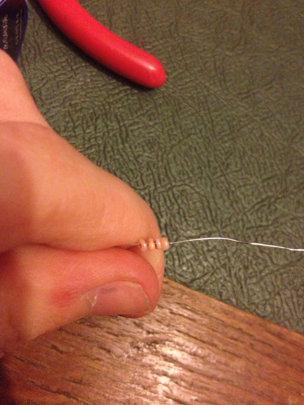 Add 4 beads to one of your wires.