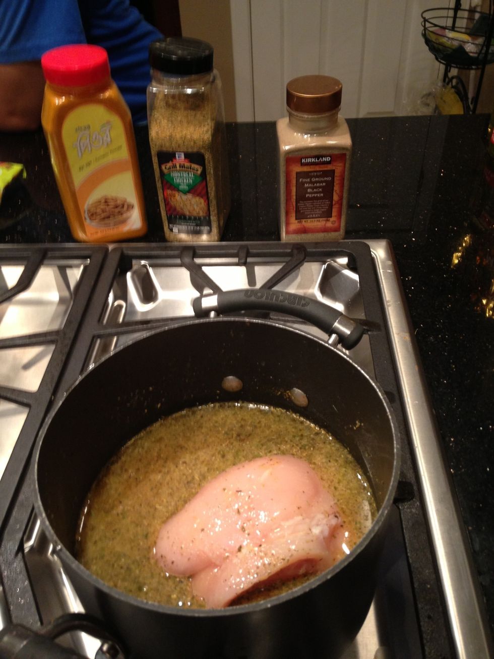 Add 4 cups water, 2 tbsp chicken seasoning, .5 tsp pepper, .5 tsp turmeric, and chicken to a pot.  Let it slow cook for 45 minutes.